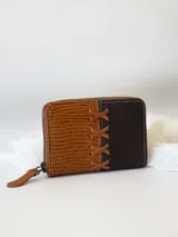 Billetera pequeña de cuero marrón y negro con cierre metálico y monedero interno.