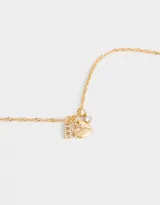 Cadena dorada con dije de strass y corazón de metal.