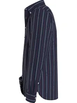 Camisa de manga larga Tommy Hilfiger de corte regular, confeccionada en algodón a rayas verticales azul marino, rojas y blancas. Presenta cuello abotonado, bolsillo de parche en el pecho y logo bordado en la manga.