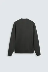 Jersey color topo de corte amplio, tejido en hilatura con mezcla de viscosa. Tiene cuello redondo, manga larga y terminaciones en rib.