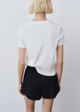 Camiseta blanca de algodón orgánico, de manga corta y cuello redondo.