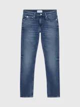 Pantalón de jean slim fit azul medio vintage, con talle bajo, cinco bolsillos y cierre con cremallera.