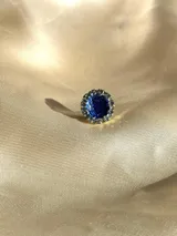 Caravana dorada con strass y resina azul, de 1cm de diámetro. Se vende por unidad.