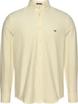 Camisa Tommy Jeans de hombre, corte slim fit, color amarillo con rayas verticales blancas, cuello abotonado, cierre con botones, puños con botones y logo bordado en el pecho.