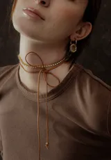 Gargantilla choker con tira de strass y tiento de cuero marrón para atar.