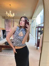 Top sin mangas con estampado abstracto en tonos grises y celestes, cuello mao con escote tipo gota y cierre con botón invisible en el cuello.