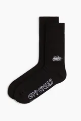 Par de medias negras de caña alta con logo de bicicleta y texto 'City Cycles' en blanco.