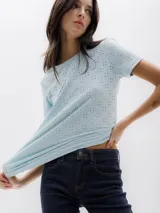 Camiseta celeste de manga corta con tejido calado y cuello redondo.