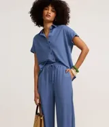 Pantalón recto color marrón claro, confeccionado en tejido orly con viscosa certificada, cintura elastizada con lazo ajustable.