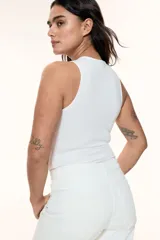 Body blanco colaless de punto elástico suave con escote redondo, sin mangas y botones a presión ocultos en la entrepierna.