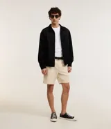 Campera marrón con cierre frontal, cuello inglés, bolsillos laterales y bajo con elástico. Presenta detalles de recortes en la parte superior. Marca Marfinno.