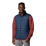 Chaleco acolchado azul marino con cierre frontal, bolsillos laterales con cierre y logo de Columbia bordado en el pecho.