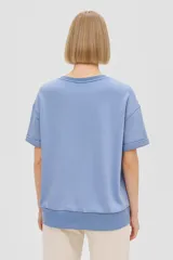 Remera color salmón de manga corta, cuello redondo y corte holgado.