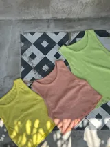 Musculosa fucsia de tejido suave y elástico, con terminaciones delicadas.