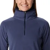 Buzo polar blanco de mujer, con cuello alto y cierre de media cremallera.