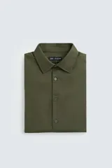 Camisa blanca de corte regular, cuello italiano, manga larga con puños abotonados y cierre frontal con botones.
