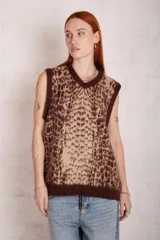 Chaleco de punto con estampado animal print en tonos beige y marrón, con cuello en V y ribetes en marrón oscuro.