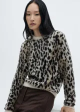 Sweater de punto con estampado animal print de leopardo en tonos beige y negro. De corte recto, cuello redondo y manga larga.