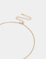 Collar de cadena dorada con dije de flor blanca con detalles rosados y centro dorado con strass.