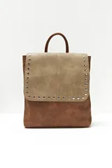 Mochila de cuero sintético color marrón y beige, con solapa con cierre de botón a presión y tachas plateadas.