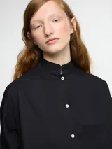 Camisa de corte clásico color blanca, con botones en la parte delantera y diseño atemporal.