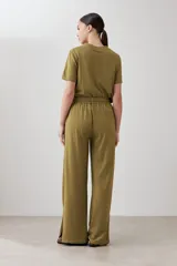 Pantalón verde oliva de corte palazzo con pretina elastizada y cordón ajustable. Incluye bolsillos laterales.