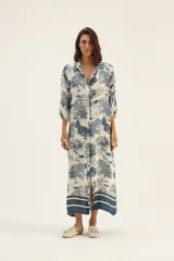 Vestido camisero largo de seda color blanco con estampado de serpientes, árboles y animales en azul.