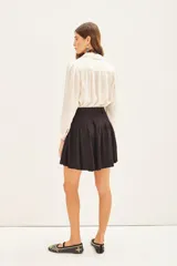 Short negro de viscosa con estampado jacquard, tiro alto y cinturón con hebilla metálica.