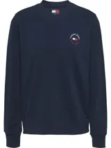 Buzo azul marino de Tommy Jeans, de corte regular y cuello redondo. Tiene un logo circular de Tommy Jeans en el pecho, que incluye el nombre de la marca y la frase new york.