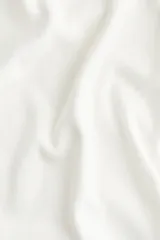 Remera corta de punto fino color blanco, entallada y con cuello redondo ribeteado acanalado.