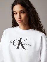Buzo blanco de felpa con corte relajado, cuello redondo, puños y dobladillo acanalados. Estampa frontal con el logo de Calvin Klein Jeans en negro.