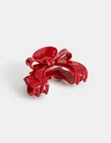 Broche para el pelo con diseño de moño color rojo.
