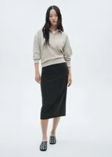 Falda midi gris oscuro de tejido de punto con cinturón negro y hebilla metálica.