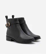 Bota de cuero negro con puntera redonda, caña corta con tirador, cierre lateral con cremallera y detalle de hebilla dorada con doble trabilla.