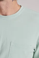 Remera de manga corta color verde menta, con cuello redondo y bolsillo en el pecho.