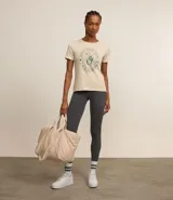 Remera deportiva color crema con estampa circular en el frente con texto 'Sports and Outdoors' y diseño de raqueta de tenis.