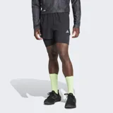 Short de running Adidas negro con calza interior ajustada. Cuenta con cintura elástica con cordón de ajuste, bolsillo lateral en la calza interior y detalles reflectantes.