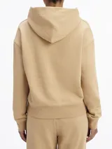 Buzo color beige de corte holgado, con capucha y logo de Calvin Klein bordado en el pecho.