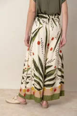 Pantalón palazzo de viscosa color crudo con estampado de hojas y flores en tonos azules y marrones. Cintura elastizada en la parte trasera.