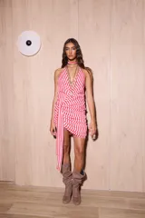 Vestido corto de gasa con estampado de rayas verticales rojas y blancas. Posee un escote pronunciado, espalda descubierta y detalle de drapeado lateral con un lazo largo multifuncional.