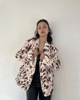 Blazer con estampado animal print color marrón y beige, con solapas y bolsillos delanteros.