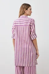 Vestido camisero a rayas verticales fucsia y blanco, con cuello camisero, mangas 3/4 con puños abotonados y cierre frontal con botones.