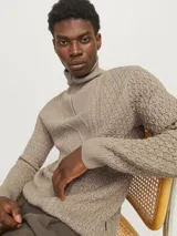 Sweater de punto color beige con cuello alto y cierre de cremallera parcial.