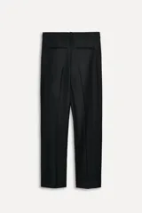 Pantalón de vestir negro de lana con corte recto, tiro bajo, trabillas para cinturón, bolsillos laterales y traseros de doble vivo.