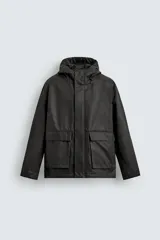 Parka relaxed fit color negro confeccionada en tejido de lino que repele el agua. Tiene cuello con capucha ajustable, mangas largas con puños abotonados, bolsillos frontales con solapa y cierre frontal con cremallera oculta por solapa con botones a presión.
