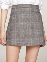 Minifalda gris con estampado de cuadros en tonos beige y negro, de corte evasé y largo a medio muslo.