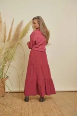 Pollera larga color bordó, con volados y elástico en la cintura.