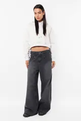 Buzo crop de frisa gamuzada color beige. Diseño con bolsillo canguro delantero, capucha con forrería interna, ojalillos metálicos de marca, cordón ajustable con punteras metálicas, puños y cintura en rib.