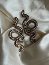 Aros colgantes con forma de serpiente azul contorneada con strass plateado.