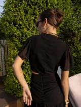 Minifalda marrón con lunares blancos, de corte ajustado con frunces y volados en el ruedo.